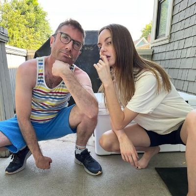 Both of them are squatting and posing like they are thinking.